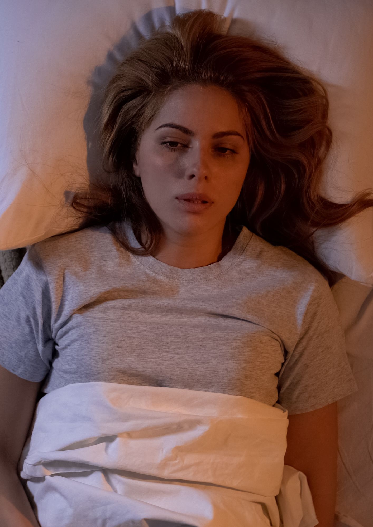 Image of a Sad Woman on her bed